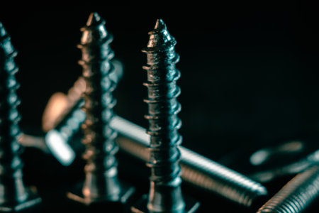 A pile of screws on a black backgroundの写真素材