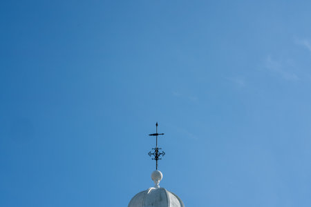 Cross on top of church against blue sky. Minimal concept with copy spaの写真素材