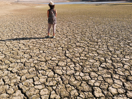 A rear view of a female on the dried-up Penne dam in Abruzzo, Italy on a sunny dayの写真素材