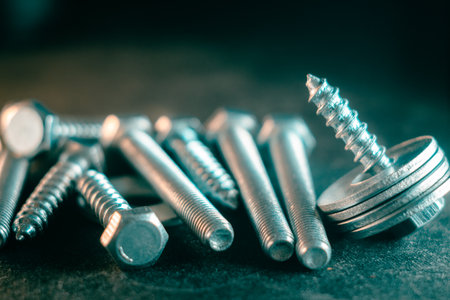 A pile of screws on a black background