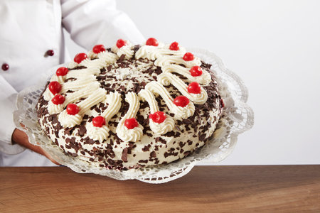 A man serving a tasty cake