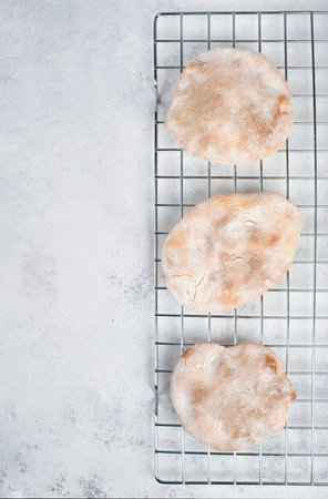 Fresh baked pita bread on a colling grid, empty copy space for text, homemade food