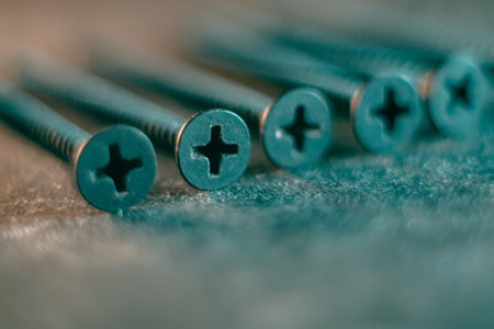 A pile of screws on a gray background