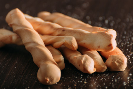 Sticks Cheese Bread in dark background and wood table
