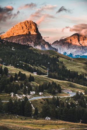 A vertical shot of the Dolomites surrounded by greenery in South Tyrol, Italyの写真素材