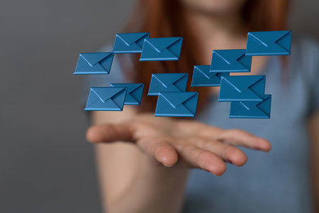 A 3D rendering of digital envelopes floating on hand- online communication conceptの写真素材