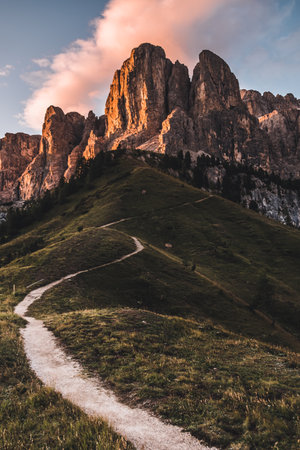 A vertical shot of the Dolomites surrounded by greenery in South Tyrol, Italyの写真素材