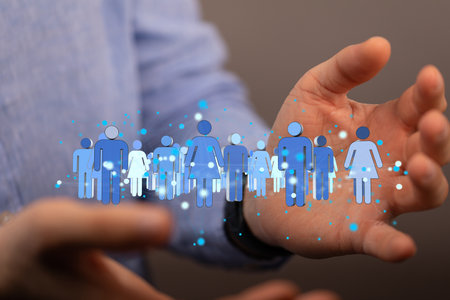 A hologram of a group of people between the palms of a businessman - social network conceptの写真素材