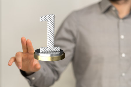 A man tapping on a 3D rendering of a number one trophyの写真素材