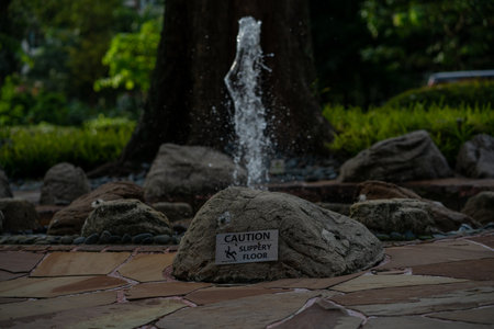 Warning symbol of slippery floor from fountain. Sign and symbol concept. Singapore