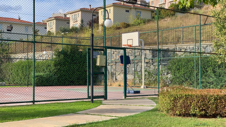An empty outdoor basketball court in a park