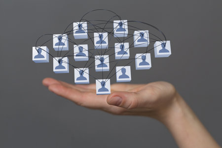 A hologram of a network of people on a woman's palm - networking conceptの写真素材