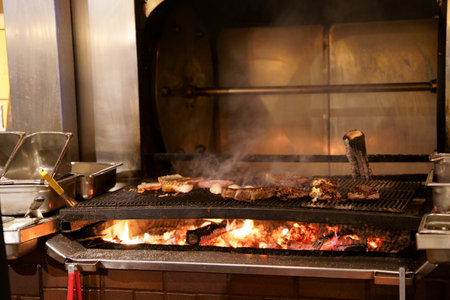 A closeup of a grill with meat being prepared