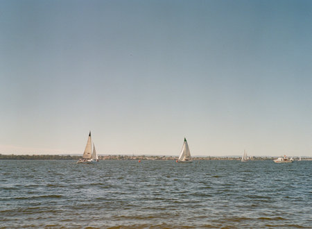 A scenic view of a morning sea and sailboats