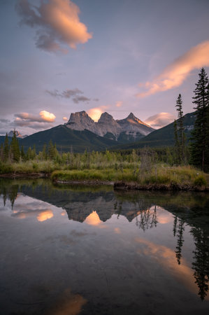 A Mesmerizing view of green hills and rocky mountains reflected on the water at sunset in Provincial Parkの写真素材