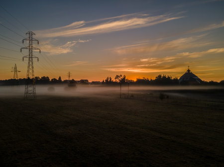 A field in the countryside in fog on a sunsetの写真素材
