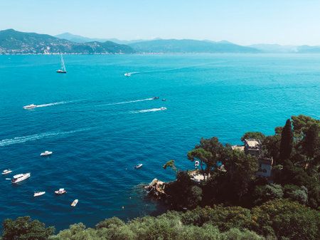 A scenic view of boats sailing on the sea under blue sky