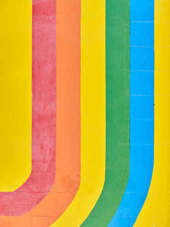 A closeup of a colorfully painted wall with strips