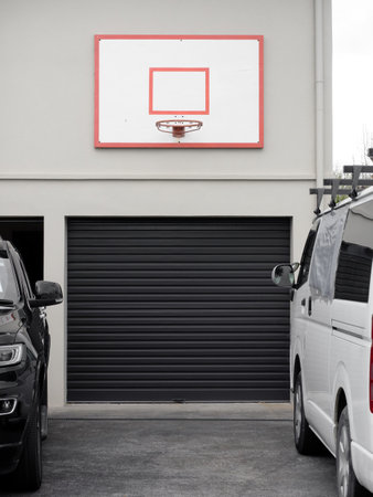 View of basketball hoop on wall above garage doorの写真素材