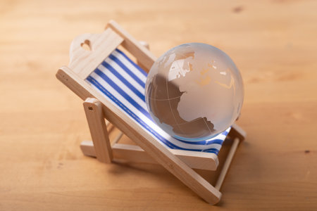 A 3d rendering of a world summer vacation beach chair on a wooden surface. summer conceptの写真素材