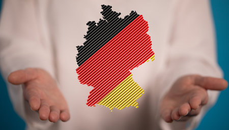 A 3D rendering of a digital german map and national flag on a blurred backgroundの写真素材