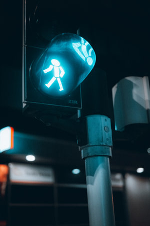 A vertical shot of a green traffic light for pedestrians.の写真素材
