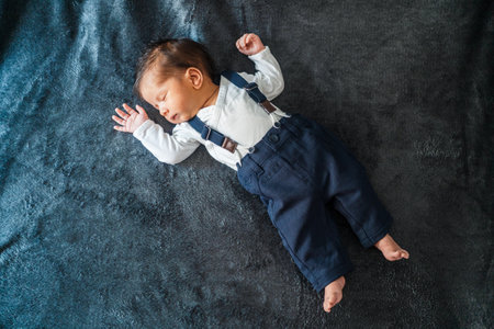 A cute Caucasian newborn baby with a fashionable costumeの写真素材