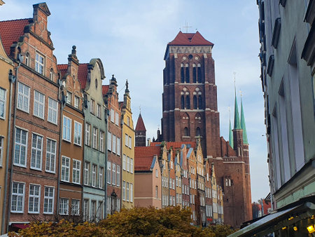 Church tower of St Marys at one end of a pretty Gdansk streeの写真素材