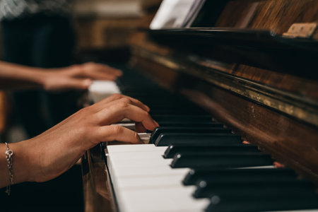 A female's hands playing the pianoの写真素材