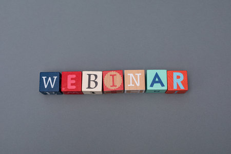 The cubes forming a word webinar isolated on grey background- coaching workshop conceptの写真素材