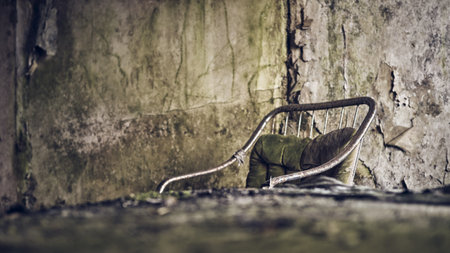 A single chair in an abandoned room with crushed walls.の写真素材