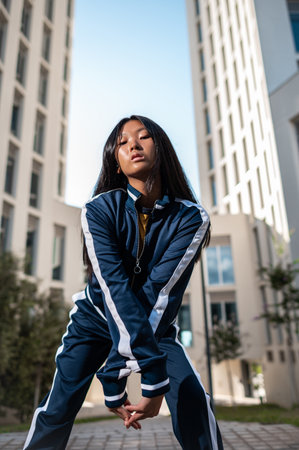 An attractive Asian woman in sportswear posing in the streetの写真素材