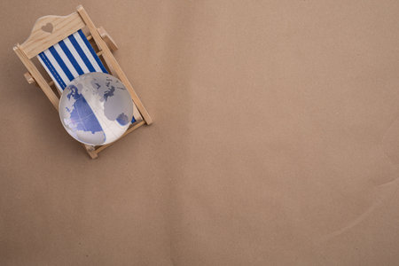 A top view of a small beach chair and a glass globe with copy space, travel and leisure conceptの写真素材