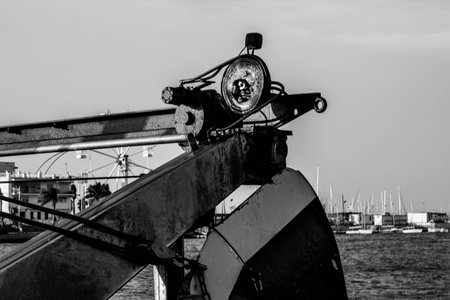 A grayscale of excalating equipment in a harbor
