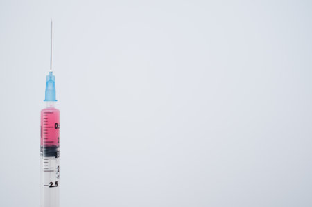 two syringes on a blue background with copyspaceの写真素材