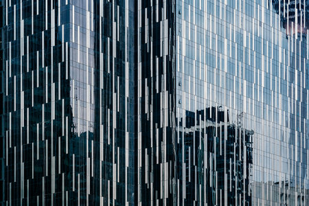 An exterior view of a modern, glass buildingの写真素材