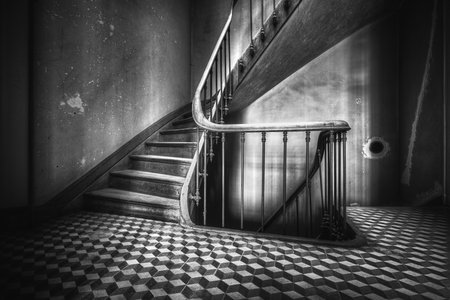 A grayscale of an old staircase and the lower floor.
