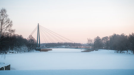 The cable bridge over frozen waterの写真素材