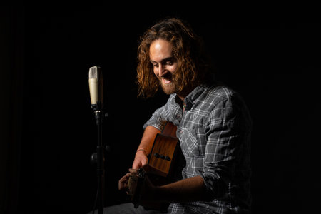 A Caucasian musician playing guitar in Spain