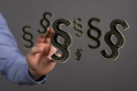 A 3D rendering of a man pointing at a digital illustration of floating law signsの写真素材