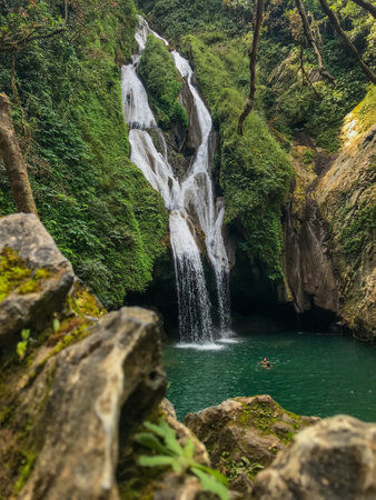 A breathtaking view of the Vegas Grande waterfalls falling into a natural pool at the Topes de...