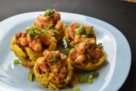 A closeup shot of appetizing cups with shrimps and vegetables on the white plate