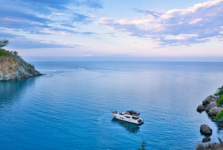 An aerial shot of a sailboat on seawater near an isの写真素材