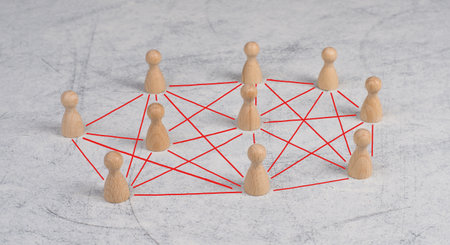 Group of wooden people connecting through red lines, communication between humansの写真素材