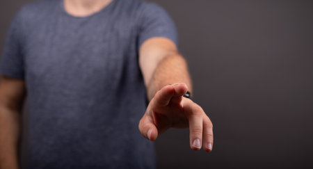 A man's hand pressing a button on a virtual screen with a copy spaceの写真素材