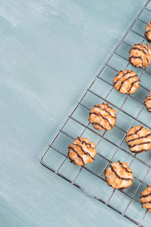Coconut macaroons on a textured blue background, sweets christmas timeの写真素材