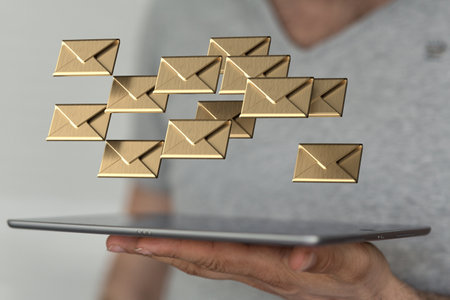 The 3D rendered message icons on a tablet in male's hand in the backgroundの写真素材