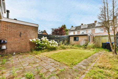 The exterior of a house with a small yard in front of itの写真素材