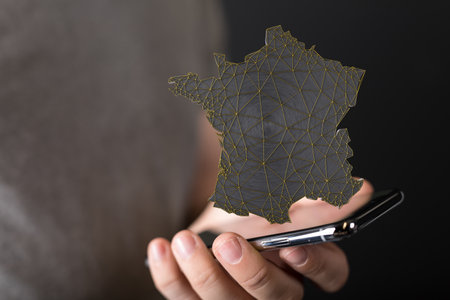 A 3D illustration of the map of France above a smartphoneの写真素材