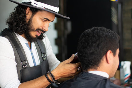 A Hispanic male hairdresser working in the beauty salonの写真素材